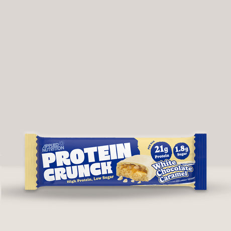 Imagine cu o bară proteică Crunch Protein Bar 62g de la APPLIED NUTRITION, o gustare delicioasă și sănătoasă cu conținut ridicat de proteine cu aromă de ciocolată albă și caramel.